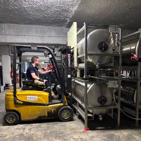tank à biere en train d'être stocké en cave tempérée dans l'entrepot Milliet par un fenwick.